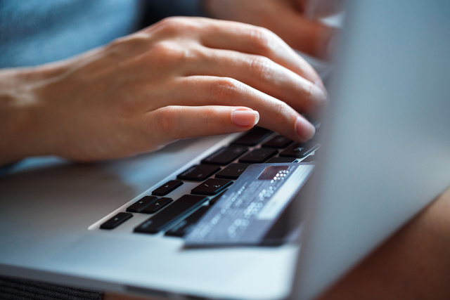 hands-using-laptop-and-credit-card-on-it-PZQ5DSN hands-using-laptop-and-credit-card-on-it-PZQ5DSN