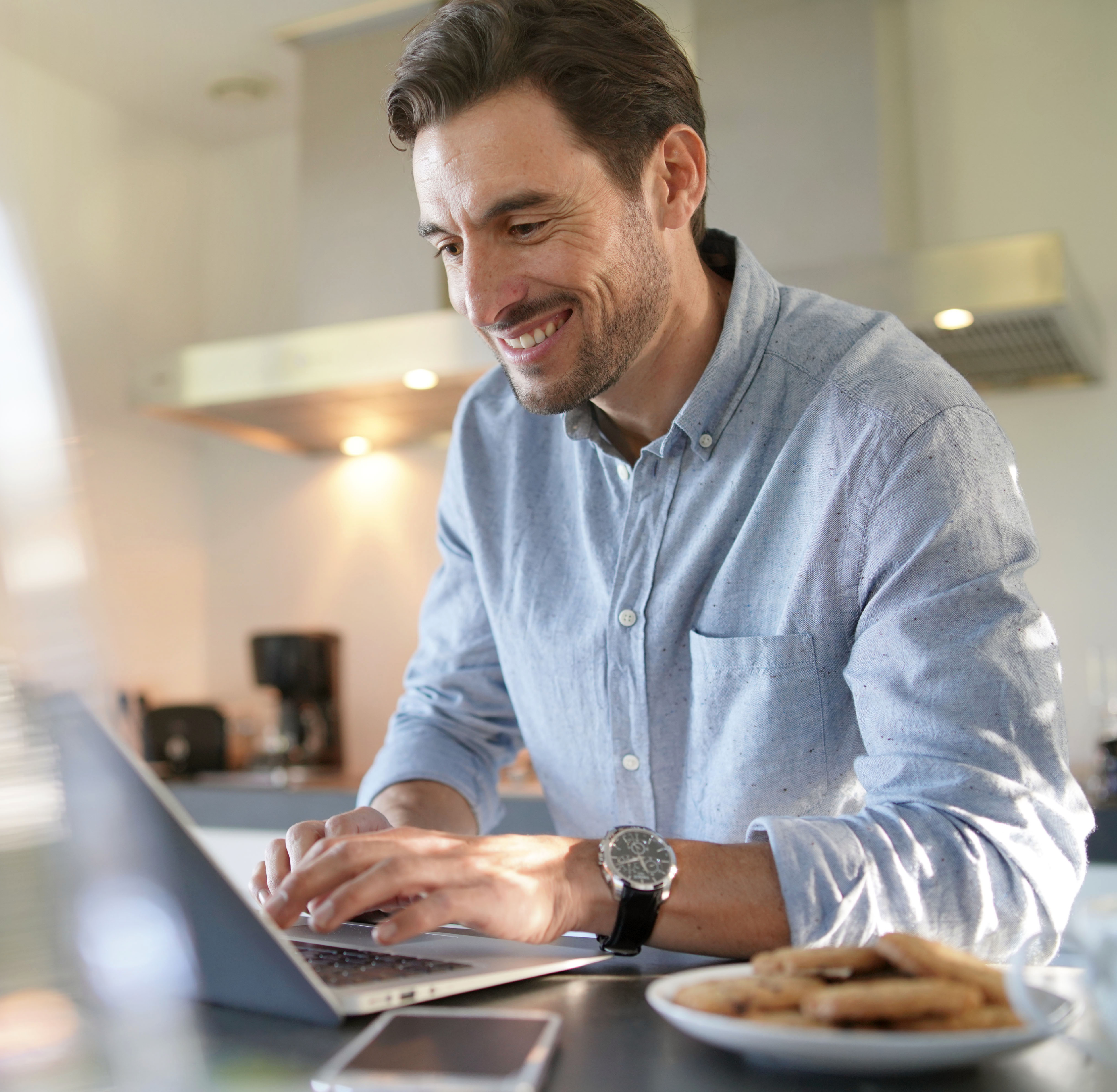 handsome-man-with-computer-modern-kitchen 1 handsome-man-with-computer-modern-kitchen 1
